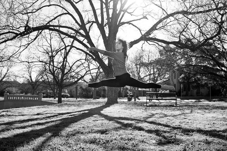 austin ballet dancer does leap in a park, austin portrait photography, black and white dancer photos