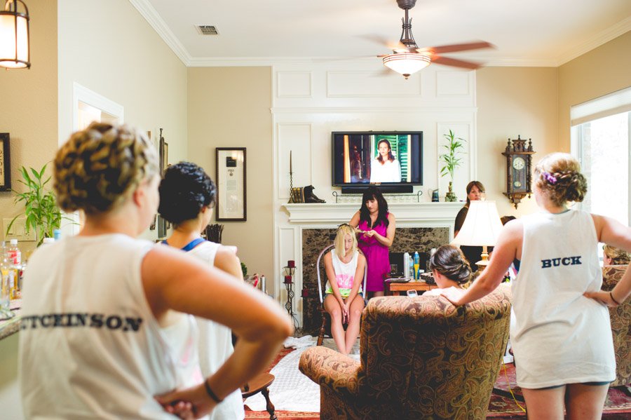 bridesmaids watch on as bride gets her hair done before her london comes to texas wedding in san antonio