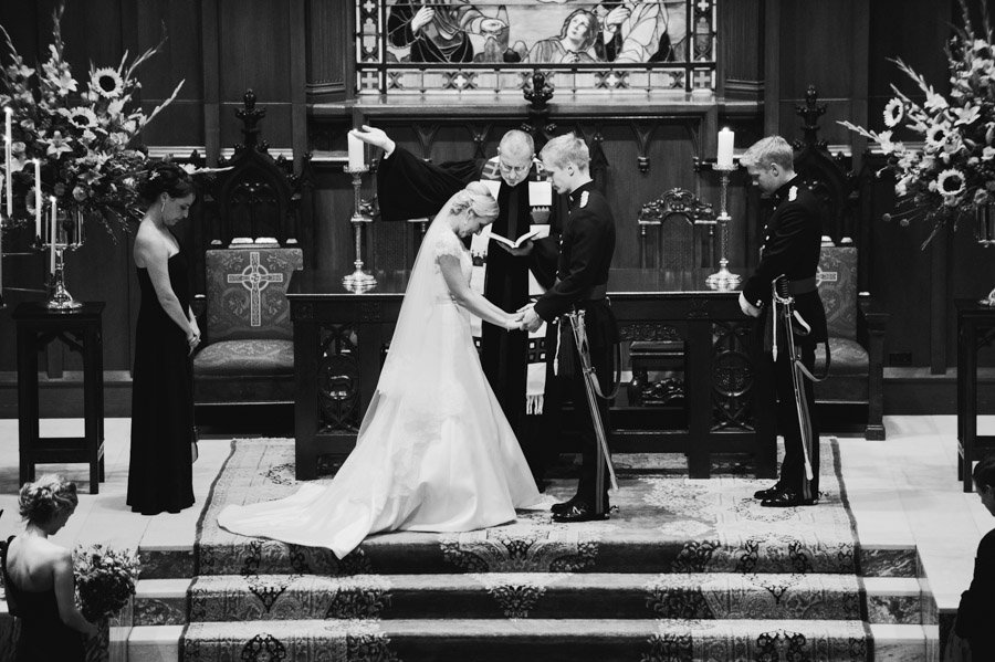 bride and groom pray and are blessed during their San Antonio wedding
