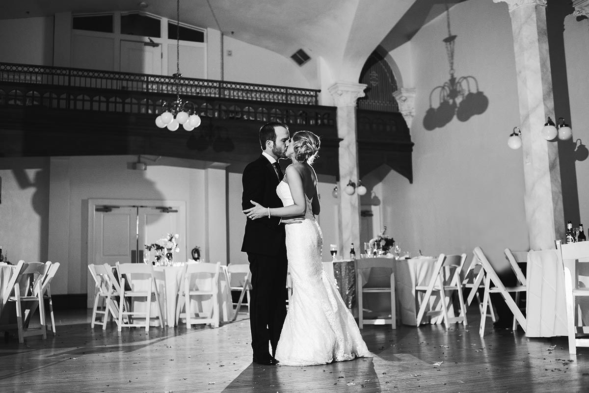 the couple shares a private last dance alone after their gold and white black tie wedding at the victory arts center in fort worth texas