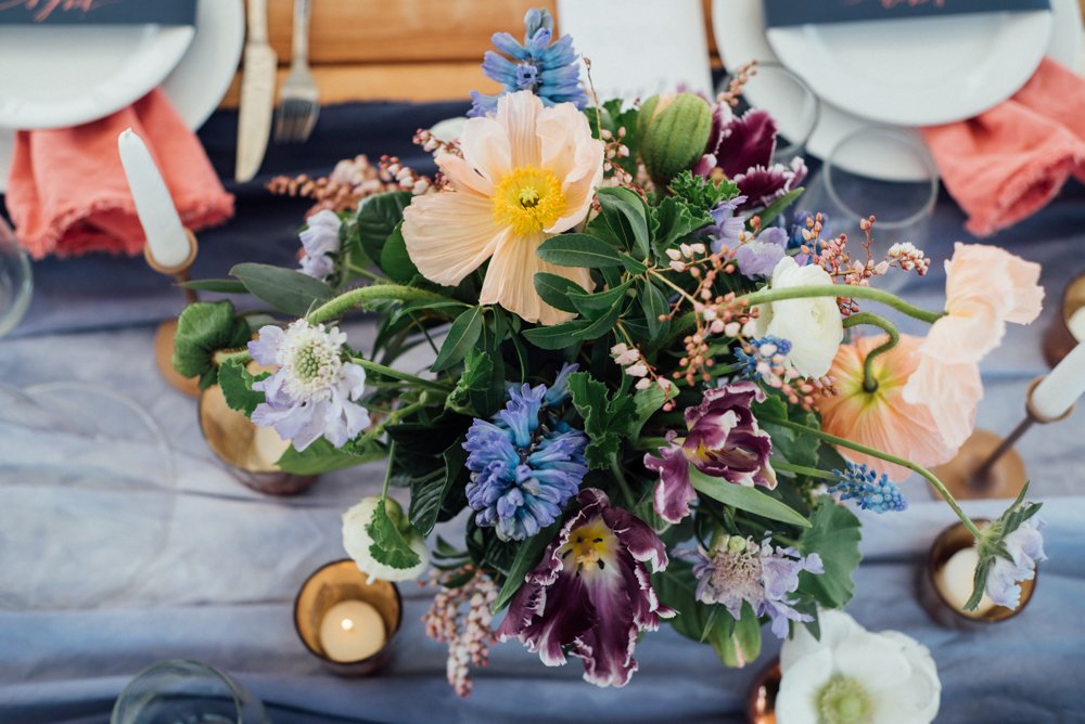 wildflower bouquet with purples and yellows, wild spring inspired wedding featuring wine cups and bluebonnets