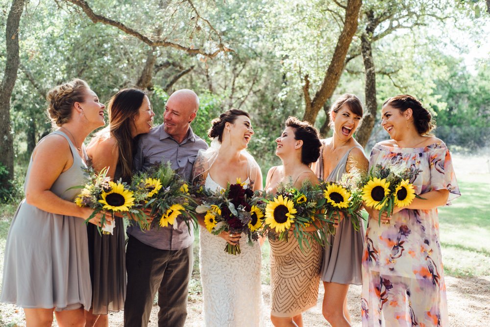 bridal party laughing holding bouquets at an outdoor wedding in austin texas