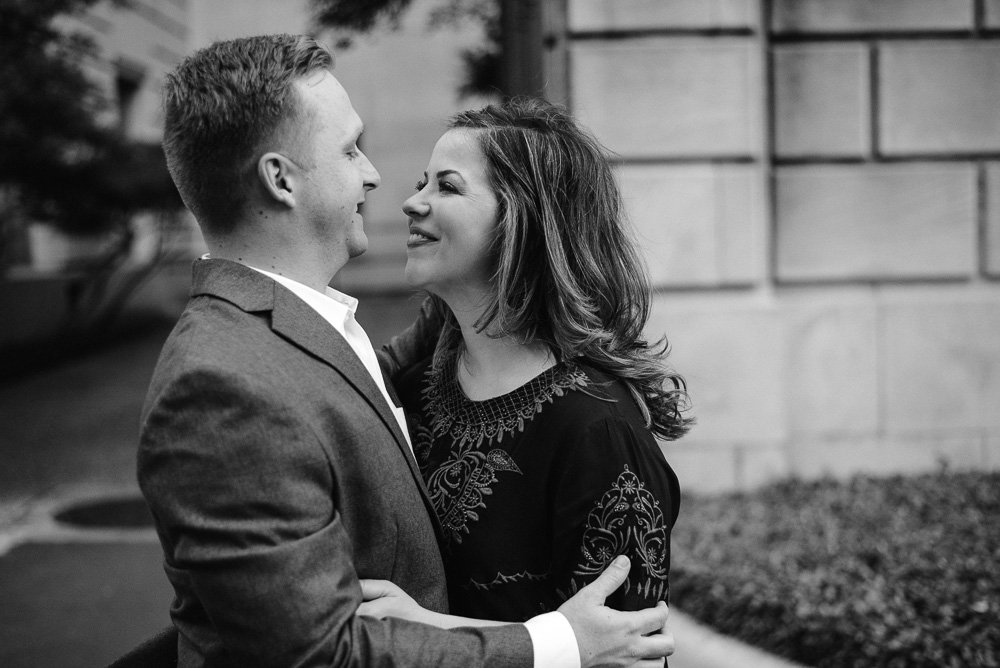 black and white photograph of a candid moment during a couples engagement session on the UT campus