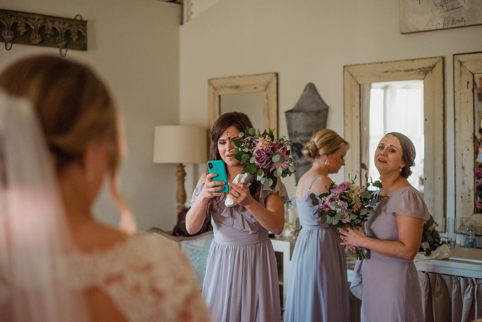 bridesmaids react to seeing bride in her dress for the first time, bridesmaids reactions, bridesmaids first look, bridesmaids in the bridal suite at henkel hall