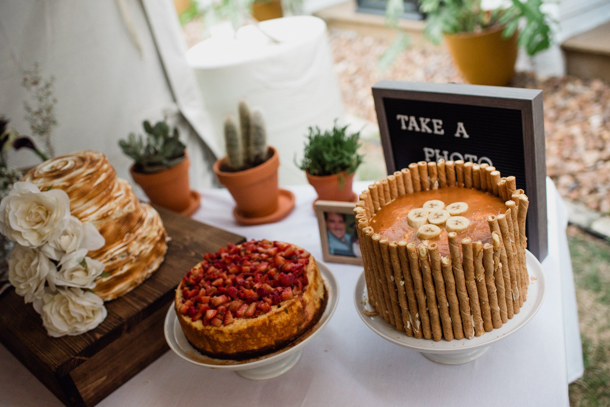 assorted wedding cake table display at a laid-back daytime san antonio wedding at king william manor