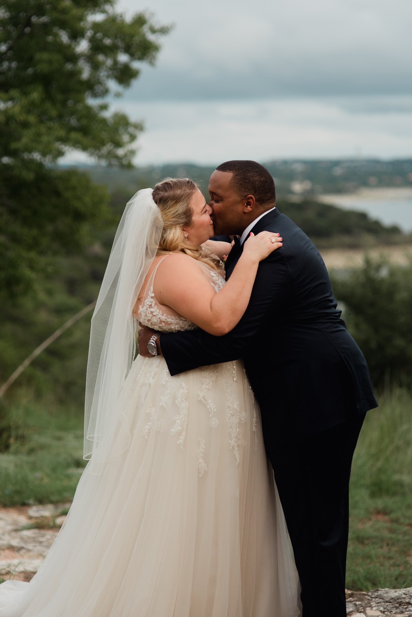 first kiss photos, outdoor wedding overlooking lake travis,
