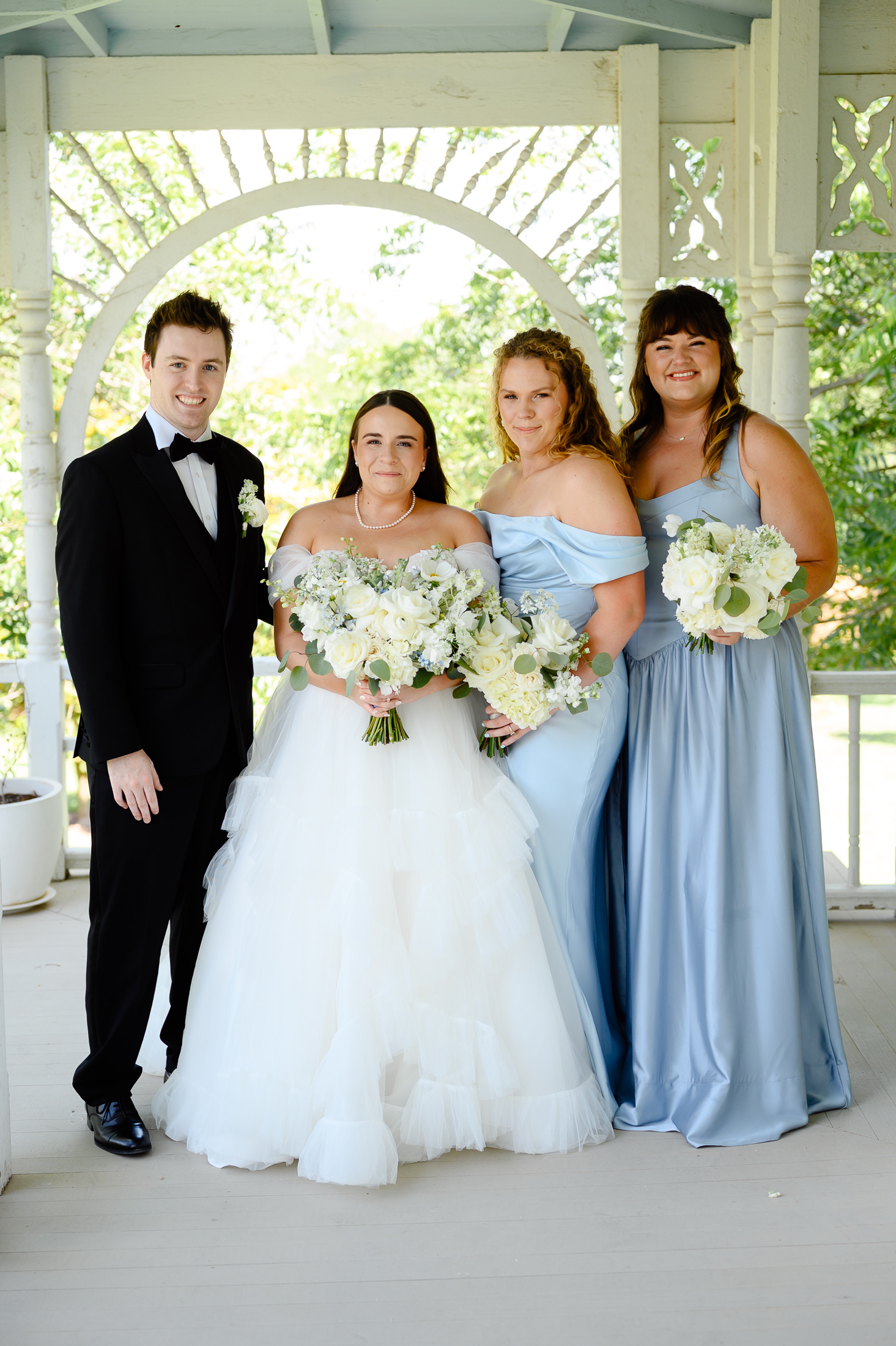 Bridesmaids and Bridesman at a wedding on the Barr Mansion porch