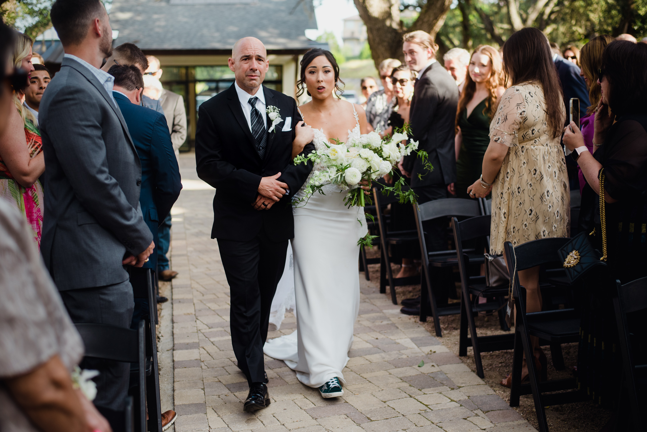 Emotional bride walks down aisle at Hayes Hollow wedding in fall.