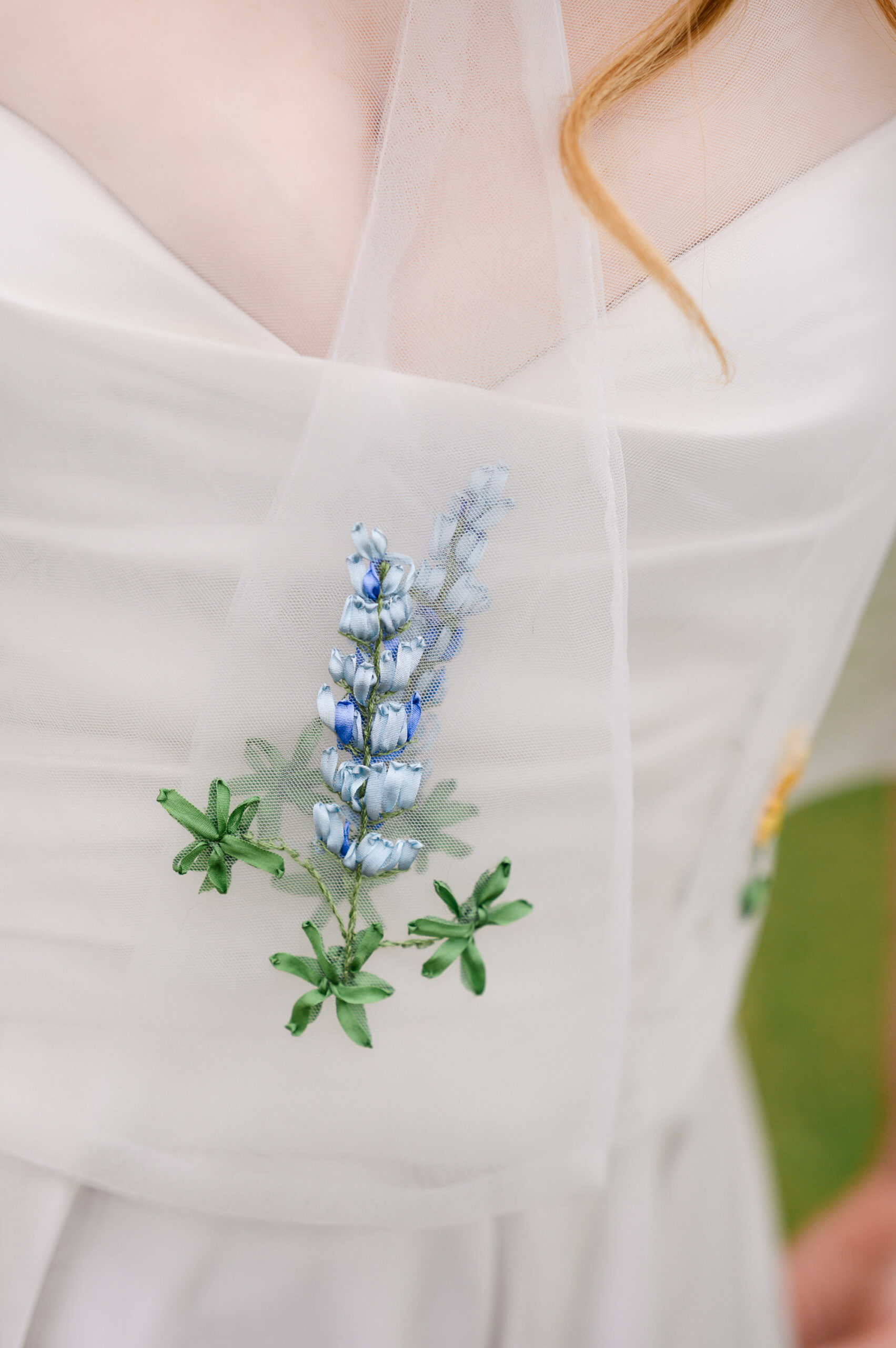 hand embroidered bluebonnet wildflower detail on bride's capelet